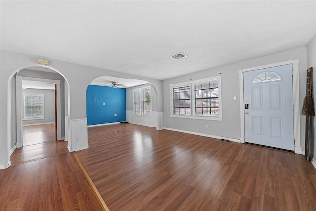 foyer entrance featuring a wealth of natural light, hardwood / wood-style floors, and ceiling fan