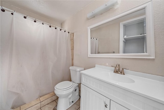 bathroom featuring tile patterned flooring, vanity, and toilet