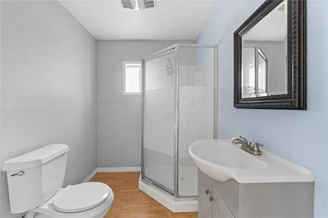 bathroom featuring hardwood / wood-style flooring, vanity, toilet, and an enclosed shower