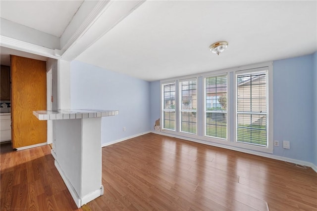 unfurnished living room with wood-type flooring