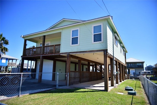 back of property featuring a patio, a garage, fence, a yard, and a carport