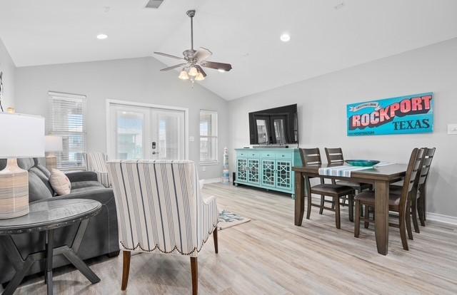 dining area featuring lofted ceiling, light wood-style flooring, recessed lighting, baseboards, and french doors