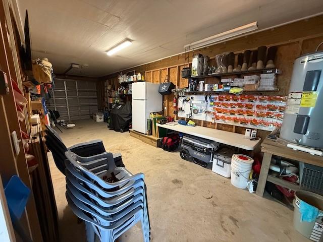 storage room with a garage and water heater