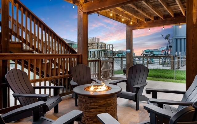 patio terrace at dusk with a fire pit and stairs