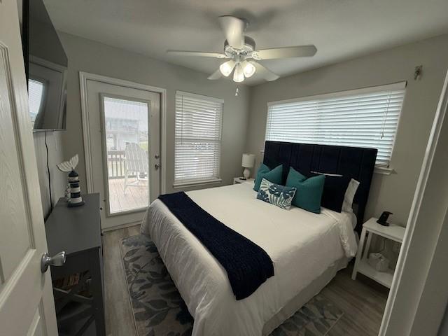 bedroom featuring access to exterior, ceiling fan, and wood finished floors