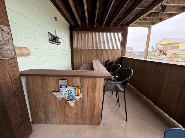 bar with carpet floors and wooden walls