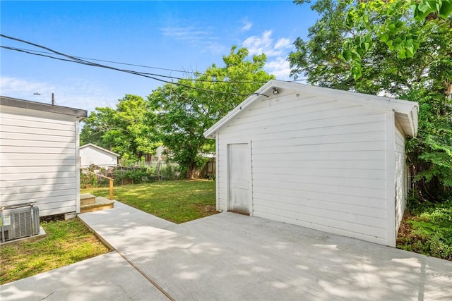 garage featuring fence and cooling unit