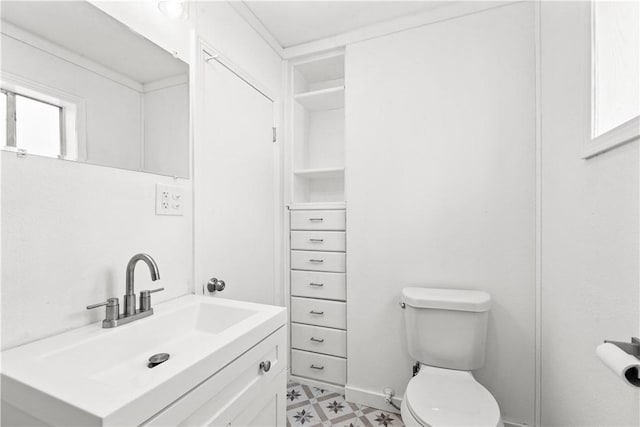 bathroom featuring toilet, tile patterned floors, and vanity