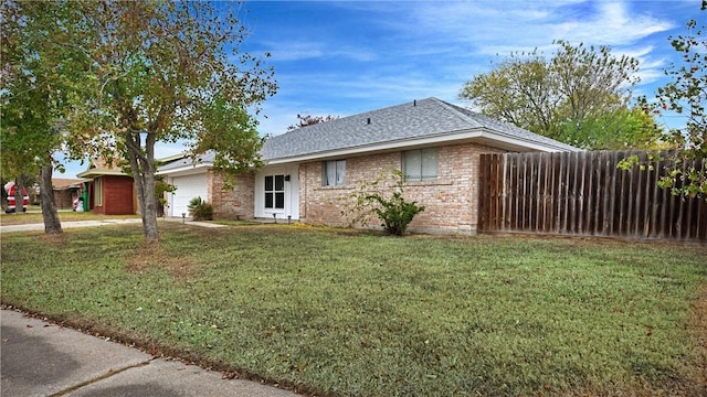 ranch-style home with a front yard and a garage