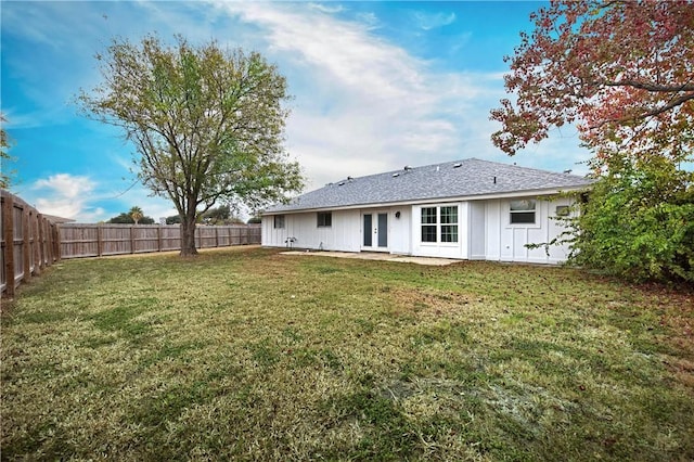 back of house with a yard and french doors