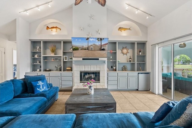 15230 Isla Pinta Ct, Corpus Christi, TX 78418 - living area with rail lighting, light tile patterned floors, a tiled fireplace, high vaulted ceiling, and ceiling fan