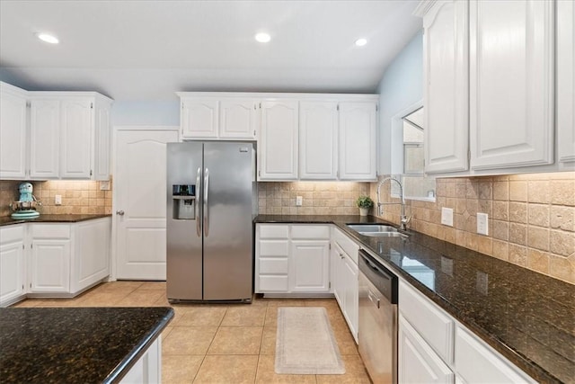 15230 Isla Pinta Ct, Corpus Christi, TX 78418 - kitchen with appliances with stainless steel finishes, dark stone countertops, backsplash, white cabinets, and recessed lighting