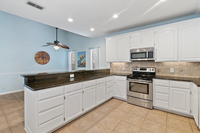 15230 Isla Pinta Ct, Corpus Christi, TX 78418 - kitchen with appliances with stainless steel finishes, a peninsula, backsplash, light tile patterned floors, and recessed lighting