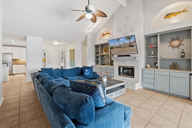 15230 Isla Pinta Ct, Corpus Christi, TX 78418 - living area with light tile patterned floors, a ceiling fan, a fireplace, beamed ceiling, and high vaulted ceiling