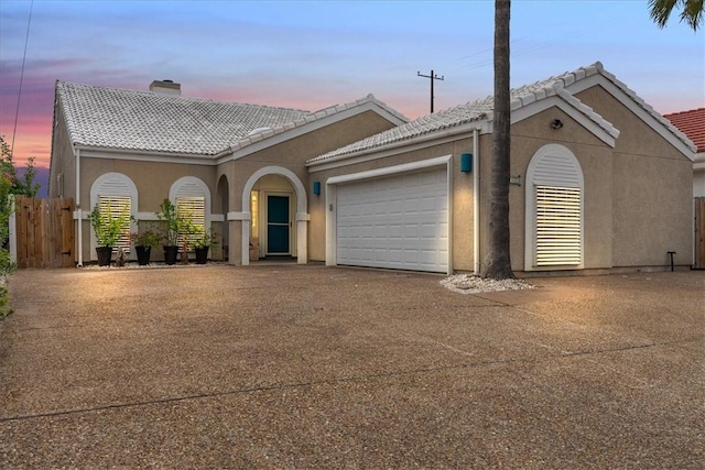 15230 Isla Pinta Ct, Corpus Christi, TX 78418 - view of front of home featuring a chimney, driveway, a tiled roof, an attached garage, and stucco siding