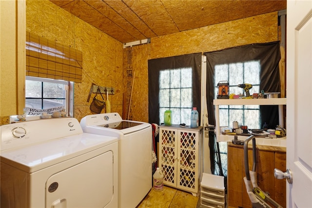 clothes washing area with a healthy amount of sunlight and independent washer and dryer