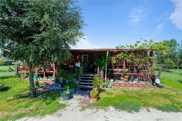 view of front of property with a patio area and a front lawn