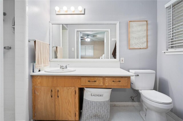 2575 Arkansas St, Ingleside, TX 78362 - bathroom featuring toilet, a ceiling fan, vanity, baseboards, and a tile shower