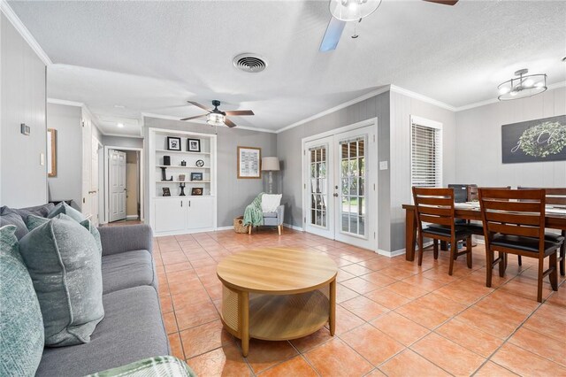 2575 Arkansas St, Ingleside, TX 78362 - living room with ceiling fan, light tile patterned floors, ornamental molding, french doors, and a textured ceiling