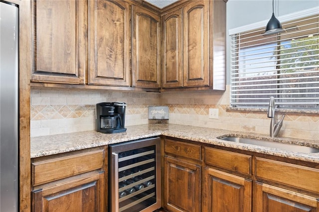 2575 Arkansas St, Ingleside, TX 78362 - kitchen with wine cooler, a sink, backsplash, and light stone countertops