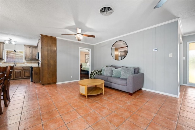 2575 Arkansas St, Ingleside, TX 78362 - living area featuring ceiling fan, ornamental molding, light tile patterned floors, and baseboards