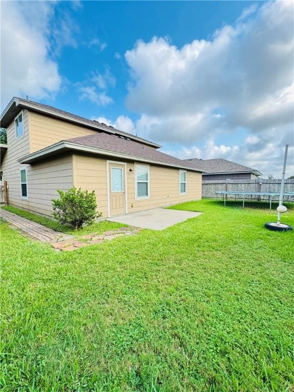 2113 Encino Dr, Corpus Christi, TX 78414 - back of property with a trampoline and a patio area