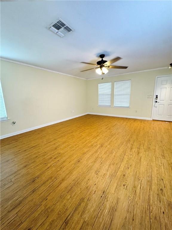 2113 Encino Dr, Corpus Christi, TX 78414 - empty room featuring ornamental molding, healthy amount of natural light, baseboards, and a ceiling fan