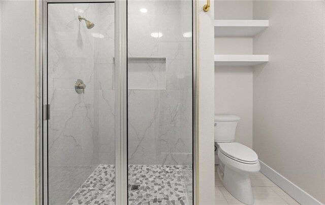 bathroom with vanity, toilet, and a shower with door