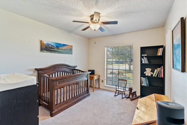 carpeted bedroom with a textured ceiling and ceiling fan