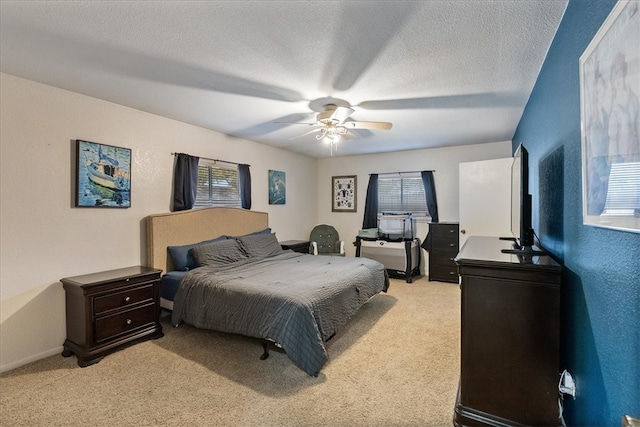 bedroom featuring light colored carpet, a textured ceiling, ceiling fan, and a textured wall