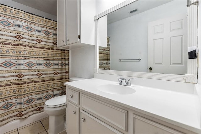 bathroom featuring visible vents, toilet, vanity, and tile patterned flooring