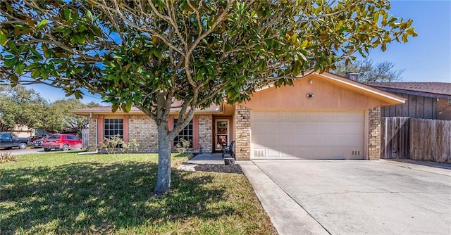 single story home with a front yard, fence, an attached garage, concrete driveway, and brick siding