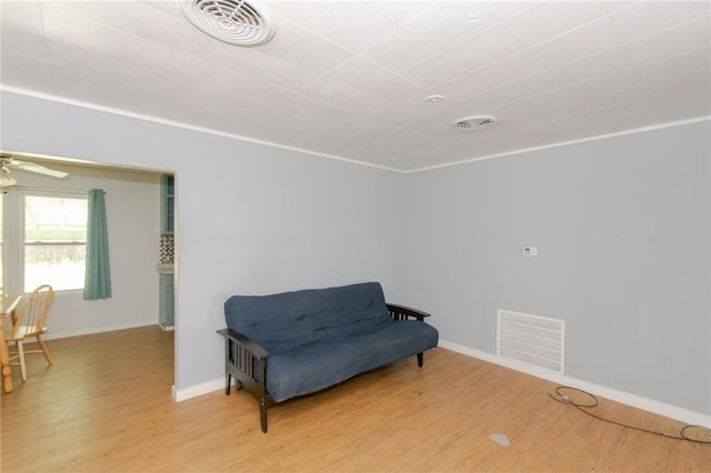 living area with ceiling fan and hardwood / wood-style flooring