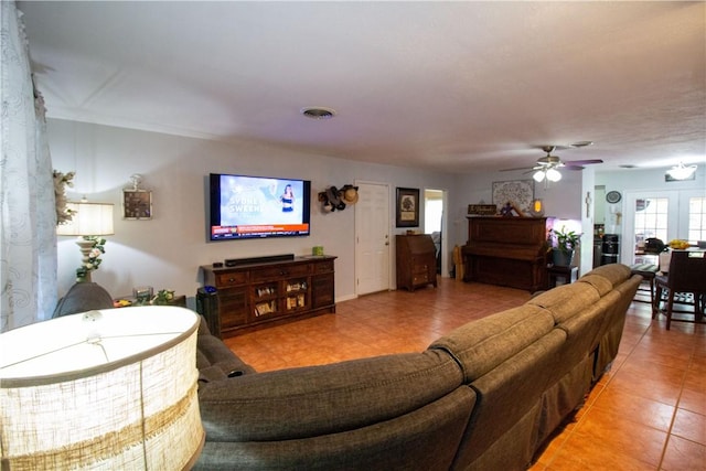 1512 Palo Blanco, Beeville, TX 78102 - living room with light tile patterned floors, visible vents, and a ceiling fan