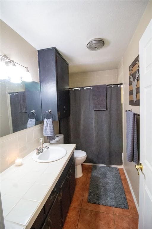 1512 Palo Blanco, Beeville, TX 78102 - bathroom with curtained shower, vanity, toilet, and tile patterned flooring