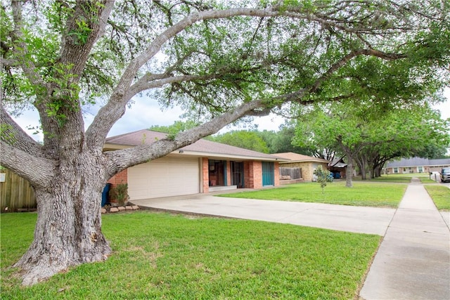 1512 Palo Blanco, Beeville, TX 78102 - ranch-style house featuring brick siding, a front lawn, concrete driveway, and an attached garage