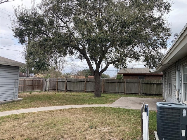 view of yard with cooling unit, a fenced backyard, and a patio area