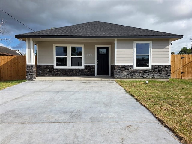 2832 Highland Ave, Corpus Christi, TX 78405 - view of front of house with stone siding, a shingled roof, and a porch