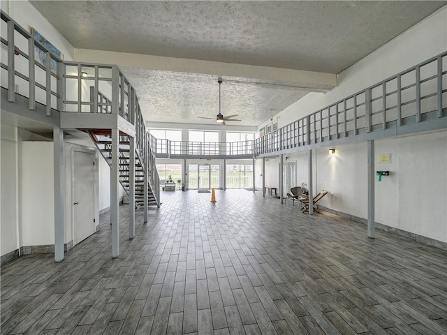 interior space with a textured ceiling, hardwood / wood-style floors, and ceiling fan