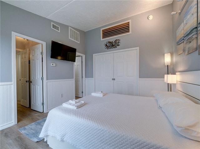 bedroom featuring light wood-type flooring and a closet