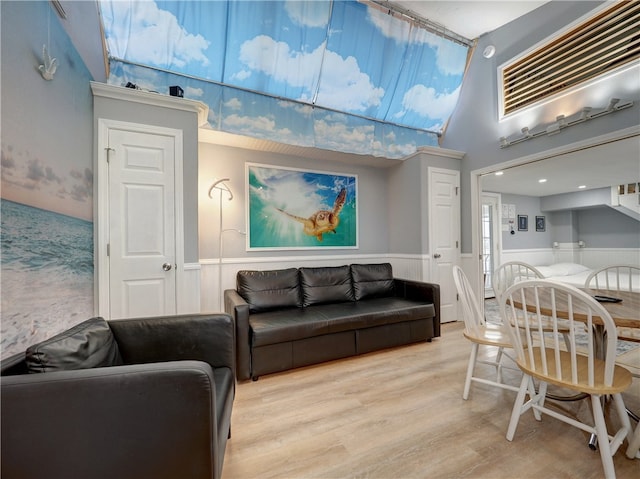 living room with light hardwood / wood-style flooring and lofted ceiling