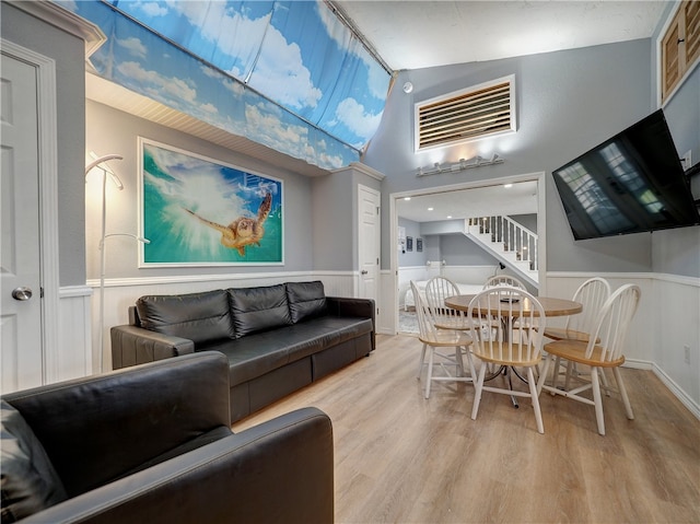 living room featuring light hardwood / wood-style floors and lofted ceiling