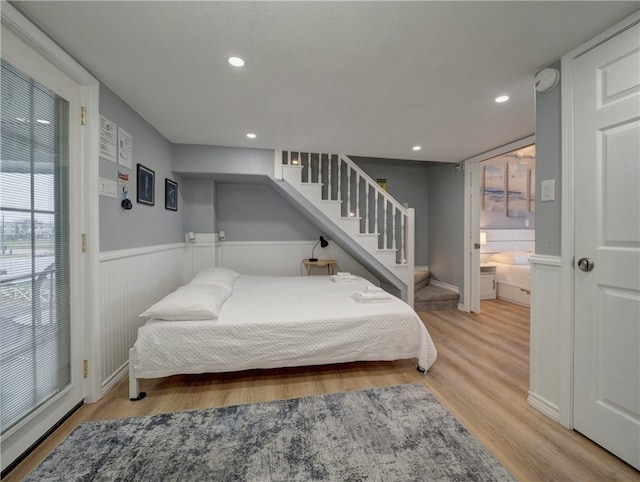 bedroom featuring light hardwood / wood-style flooring and connected bathroom