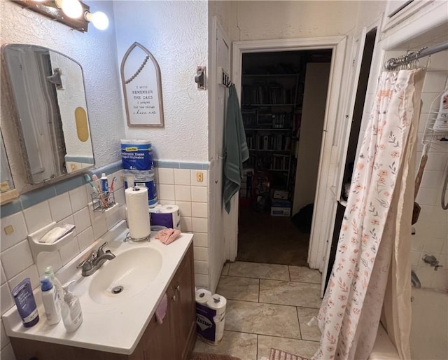 3751 Wilson Dr, Corpus Christi, TX 78408 - bathroom with vanity, tile walls, shower / bathtub combination with curtain, and wainscoting