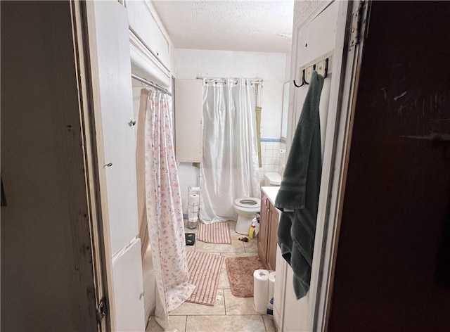 3751 Wilson Dr, Corpus Christi, TX 78408 - full bathroom with tile patterned flooring, a shower with curtain, vanity, and a textured ceiling