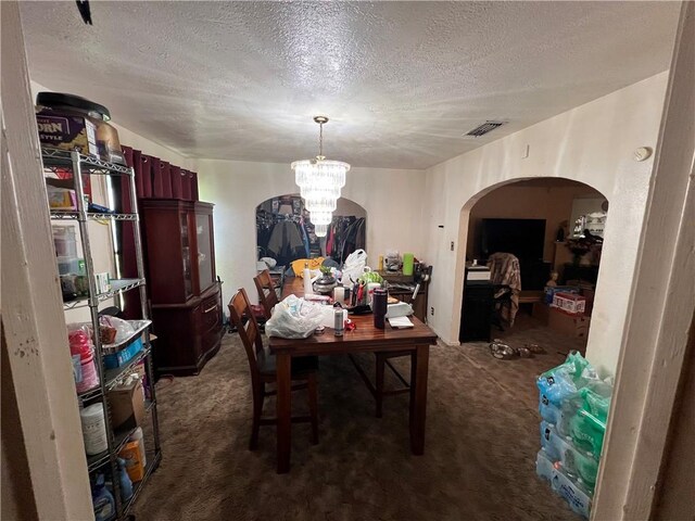 3751 Wilson Dr, Corpus Christi, TX 78408 - dining area with arched walkways, a chandelier, dark colored carpet, and a textured ceiling