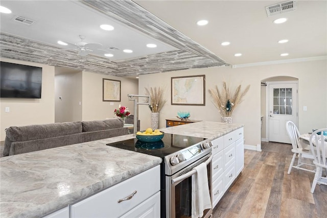 1214 Enterprise Blvd, Rockport, TX 78382 - kitchen featuring visible vents, wood finished floors, crown molding, and stainless steel electric range