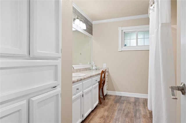 1214 Enterprise Blvd, Rockport, TX 78382 - bathroom with vanity, ornamental molding, baseboards, and wood finished floors