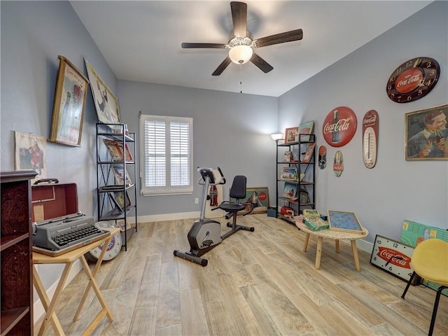 exercise room featuring ceiling fan and light hardwood / wood-style flooring