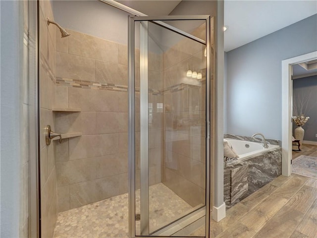 bathroom featuring hardwood / wood-style flooring and plus walk in shower